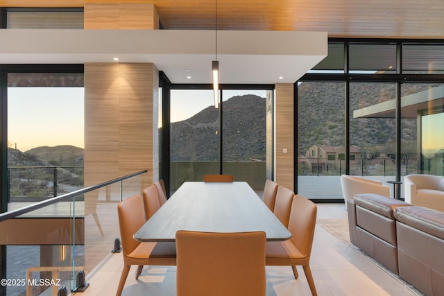 tiled dining room with floor to ceiling windows and a mountain view