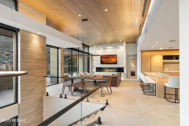 dining room with sink, wood ceiling, and light tile patterned flooring