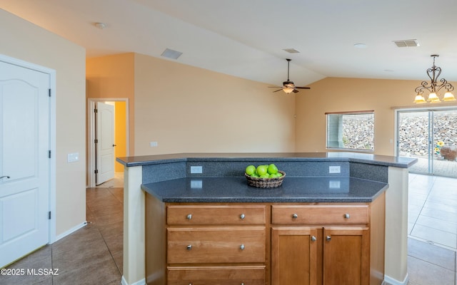 kitchen featuring tile patterned flooring, ceiling fan with notable chandelier, and vaulted ceiling