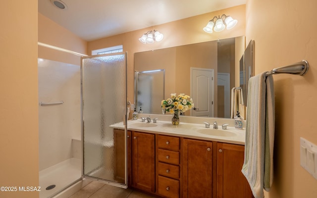 bathroom featuring vanity, a shower with shower door, and tile patterned floors