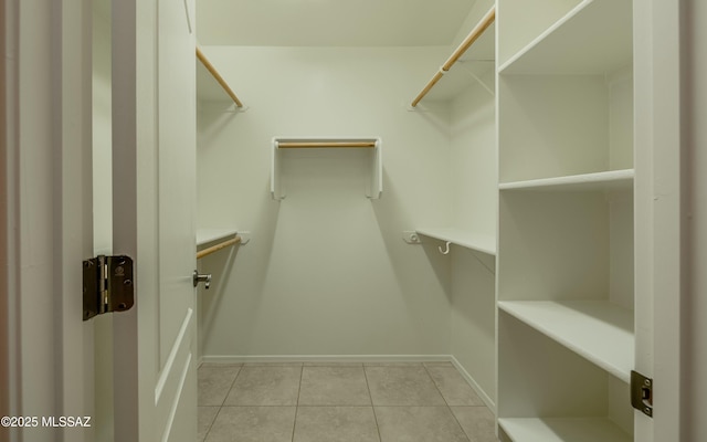 spacious closet with light tile patterned floors