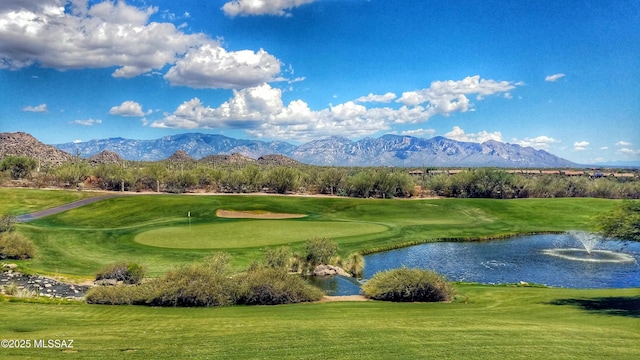 surrounding community featuring a water and mountain view and a yard