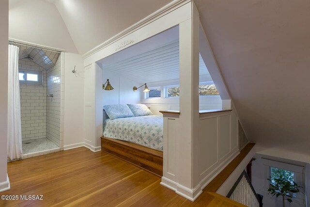 doorway featuring hardwood / wood-style floors and crown molding