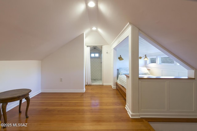 bedroom with vaulted ceiling and hardwood / wood-style floors