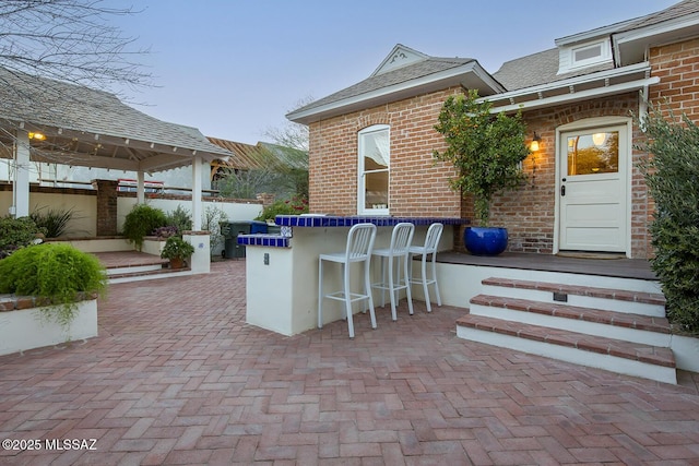 view of patio / terrace with a bar and a gazebo