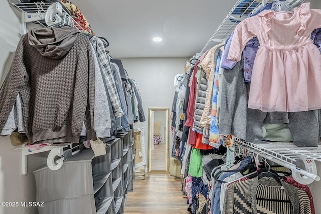 walk in closet with light wood-type flooring