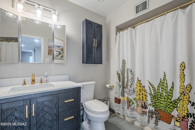 bathroom with vanity, tile patterned floors, and toilet