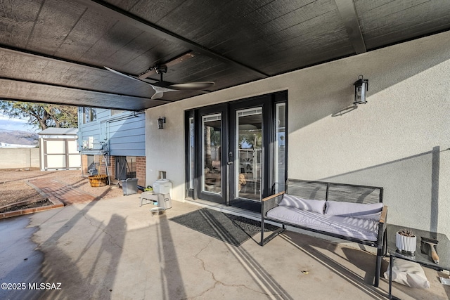 view of patio / terrace featuring ceiling fan and a storage unit