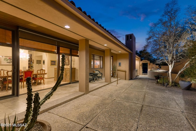 view of patio terrace at dusk