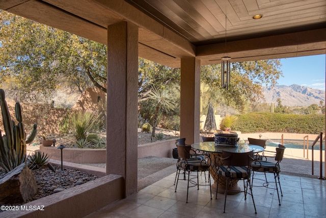 sunroom / solarium with a mountain view and wood ceiling