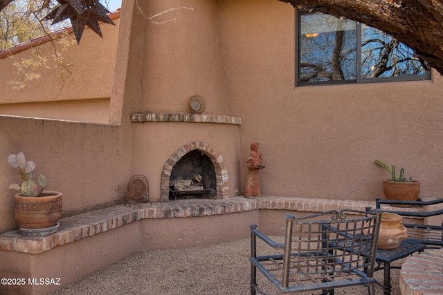 view of patio / terrace featuring a brick fireplace