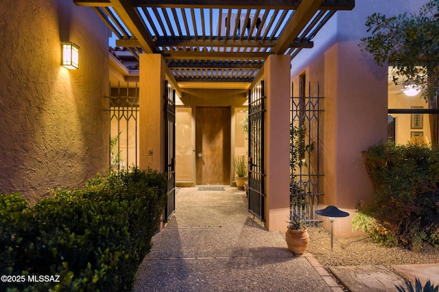 entrance to property with a pergola