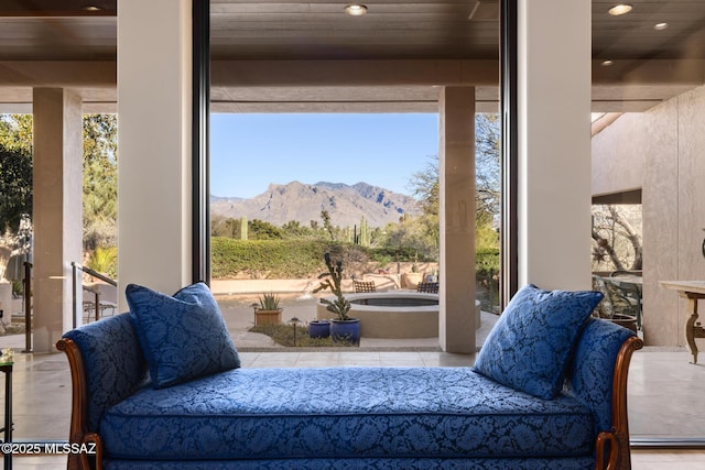 living area featuring a mountain view and wooden ceiling