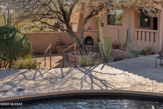 exterior space with exterior fireplace and a patio