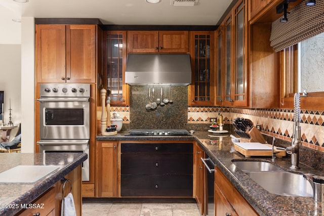 kitchen featuring double oven, sink, decorative backsplash, exhaust hood, and black cooktop