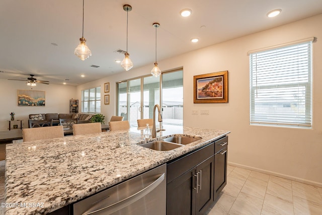 kitchen featuring sink, hanging light fixtures, dishwasher, ceiling fan, and light stone countertops