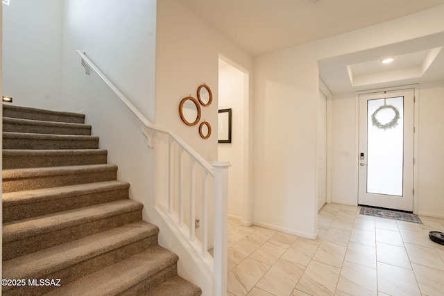 entryway with a raised ceiling