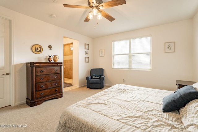 carpeted bedroom featuring ceiling fan and ensuite bathroom