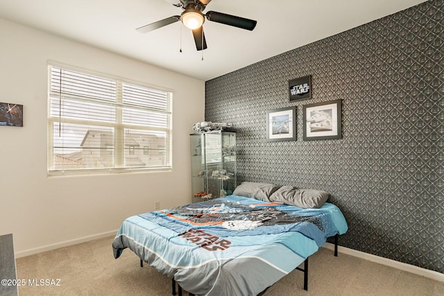 bedroom featuring light colored carpet and ceiling fan