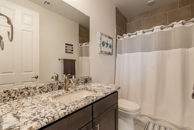 bathroom featuring vanity, toilet, and a shower with shower curtain