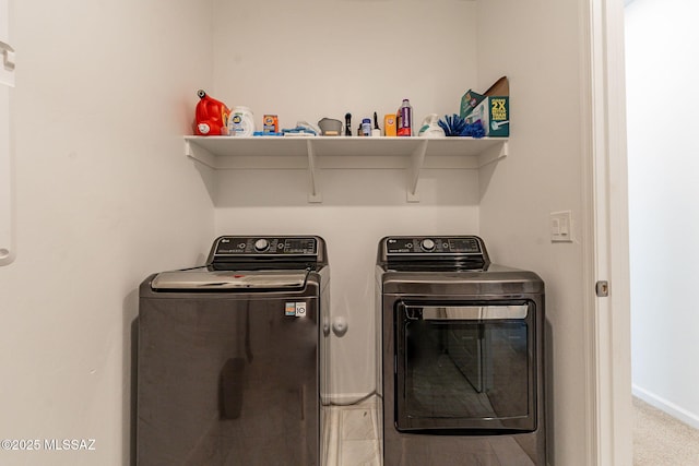 washroom with washing machine and clothes dryer