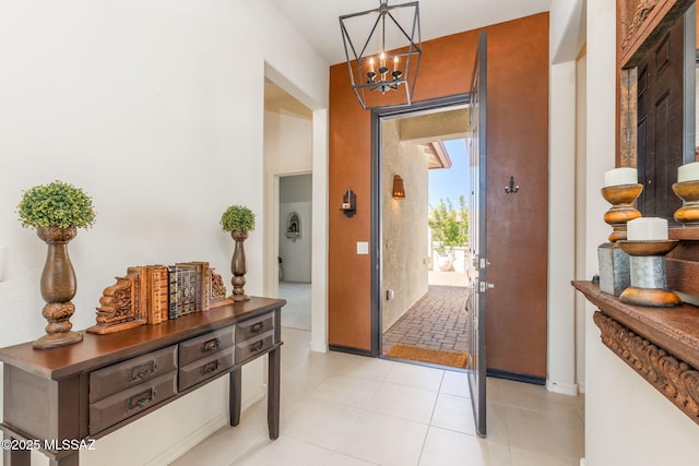 foyer featuring light tile patterned flooring and a notable chandelier