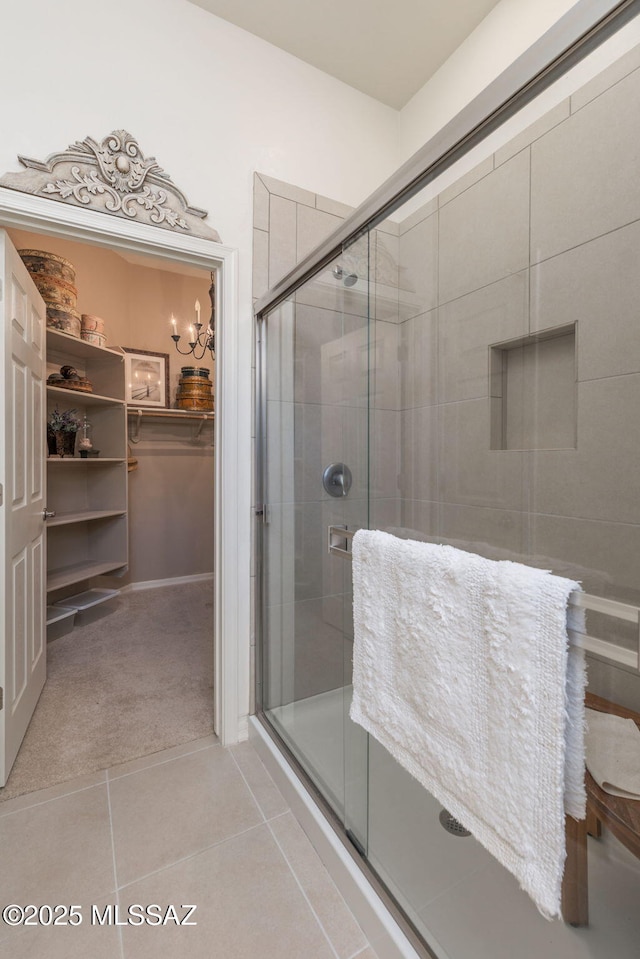 bathroom featuring tile patterned flooring and an enclosed shower