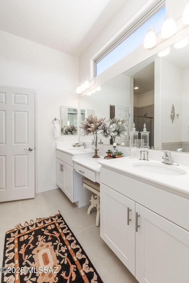 bathroom with tile patterned flooring, vanity, and a shower with door