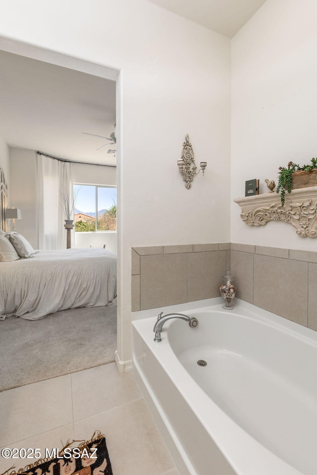 bathroom featuring ceiling fan, a bath, and tile patterned flooring