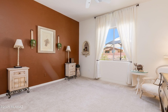 sitting room with light colored carpet and ceiling fan