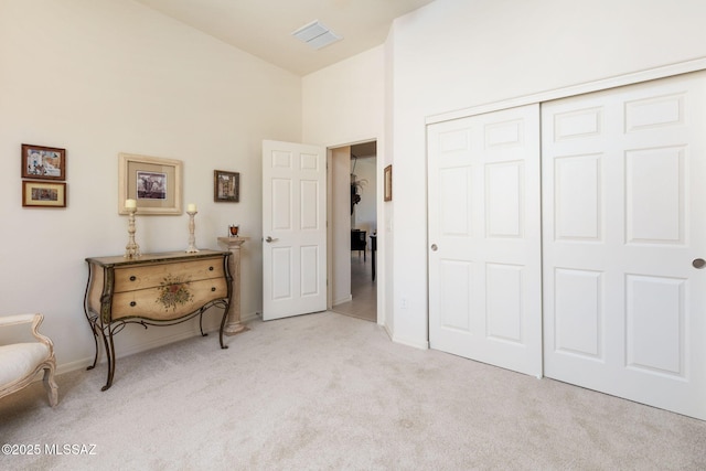 interior space featuring a towering ceiling and a closet