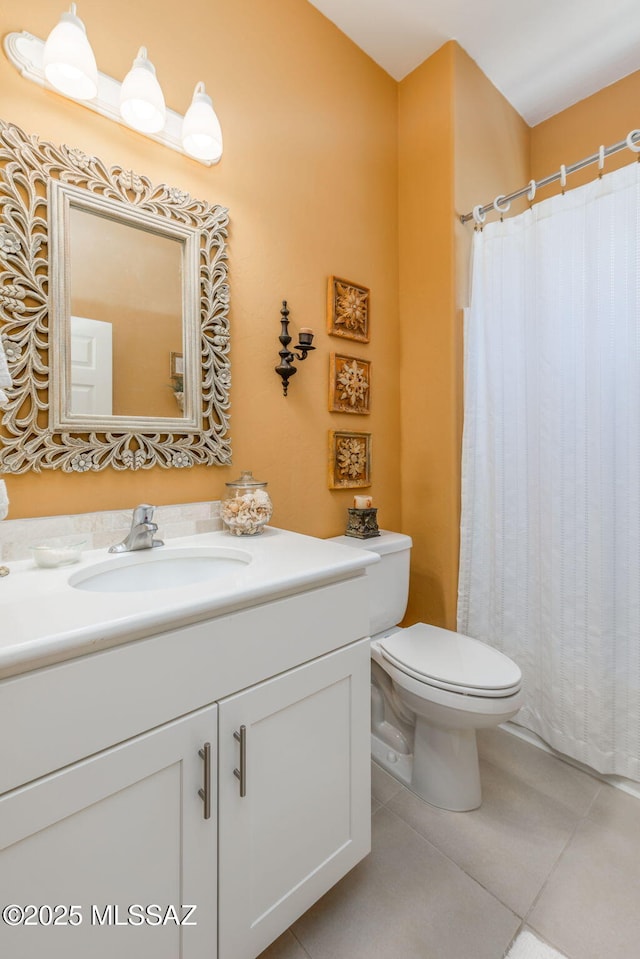 bathroom featuring tile patterned floors, toilet, a shower with shower curtain, and vanity