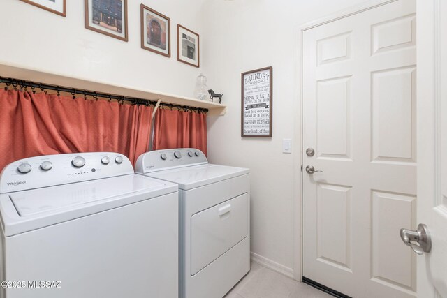 washroom featuring light tile patterned floors and washing machine and clothes dryer