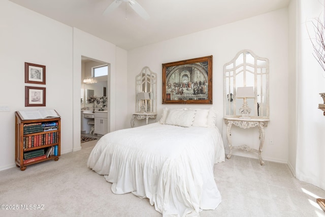 bedroom featuring light carpet, connected bathroom, and ceiling fan