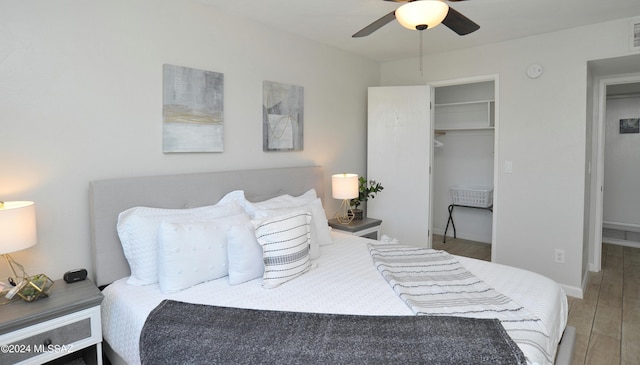 bedroom with hardwood / wood-style flooring, ceiling fan, and a closet