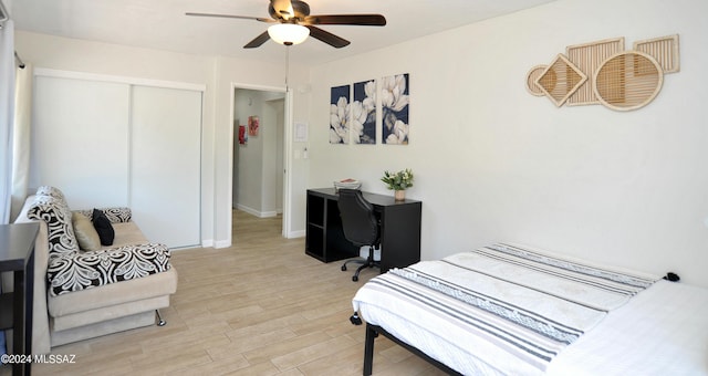 bedroom featuring ceiling fan, a closet, and light wood-type flooring