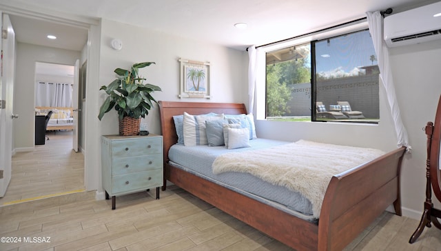 bedroom featuring an AC wall unit