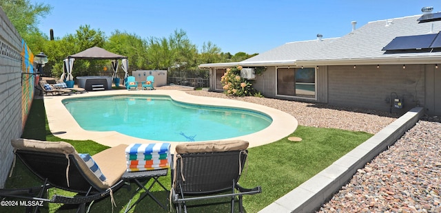 view of pool with a gazebo and a hot tub