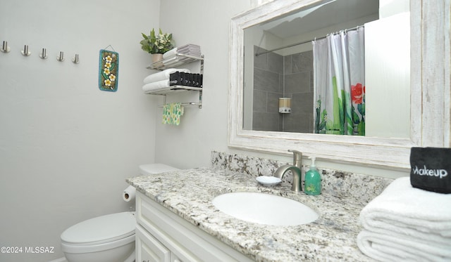 bathroom with a shower with curtain, vanity, and toilet