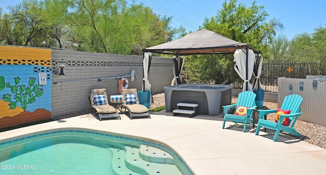 view of pool with a gazebo, a hot tub, and a patio