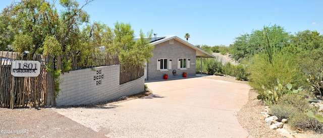 view of front of house featuring an outbuilding and solar panels