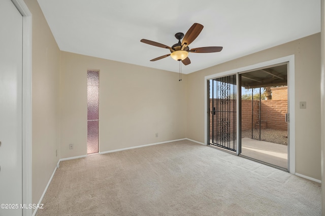 carpeted spare room featuring ceiling fan