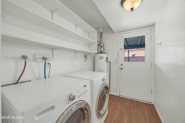 washroom with hardwood / wood-style flooring, gas water heater, and independent washer and dryer