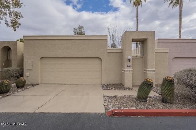 pueblo-style house featuring a garage