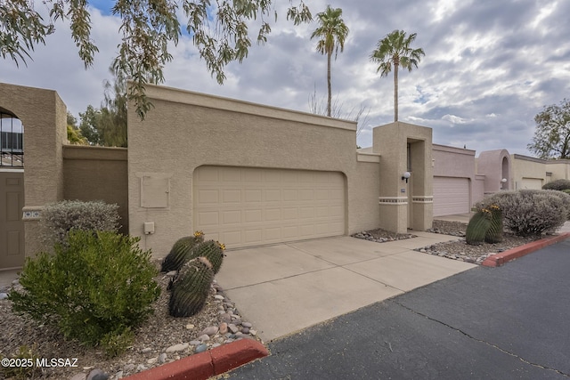 pueblo-style home with a garage