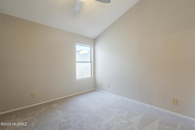 spare room featuring ceiling fan, vaulted ceiling, carpet, and a textured ceiling