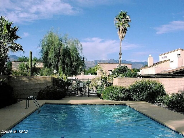 view of swimming pool with a mountain view