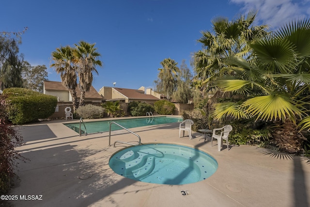 view of pool with a hot tub and a patio area