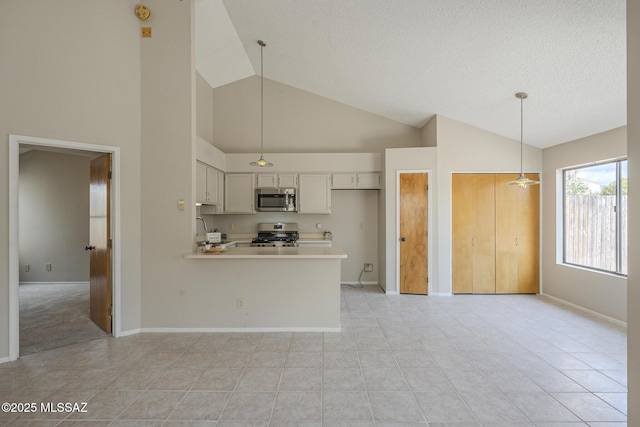 kitchen with sink, hanging light fixtures, stainless steel appliances, white cabinets, and kitchen peninsula