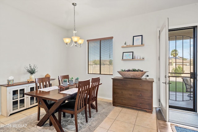 tiled dining area with a chandelier